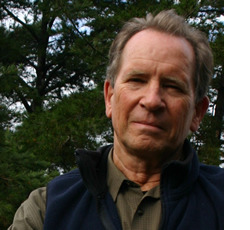 portrait image of michael davidson with coniferous trees in background