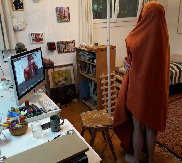 Annie Abrahams stands in a bedroom with a blanket over her head, recording her breathing.