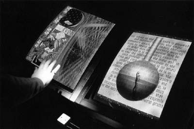 Hand over screen. "Alchemy",  Interactive digital video installation, Simon Biggs (1990) 