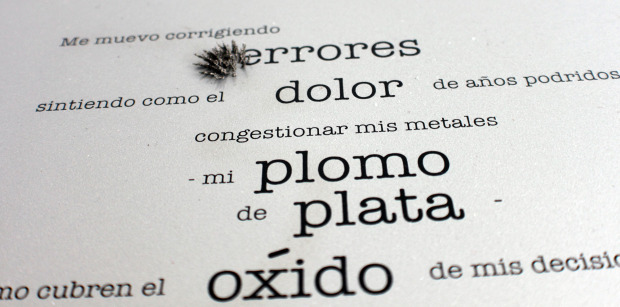 Black text—of varying size and weight—with metal filings on a the word ending with errores.