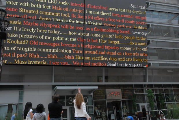 Four screens filled with differently colored sentences in public