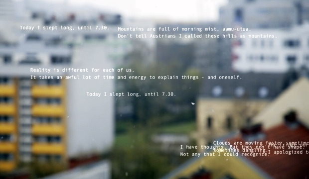 Still of "Kinesics of Letters", March 2020. White text floats over an out of focus cityscape.